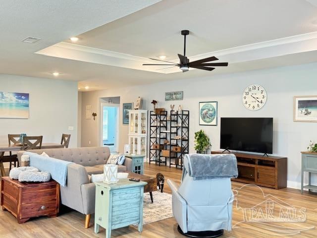 living room with ceiling fan and wood-type flooring