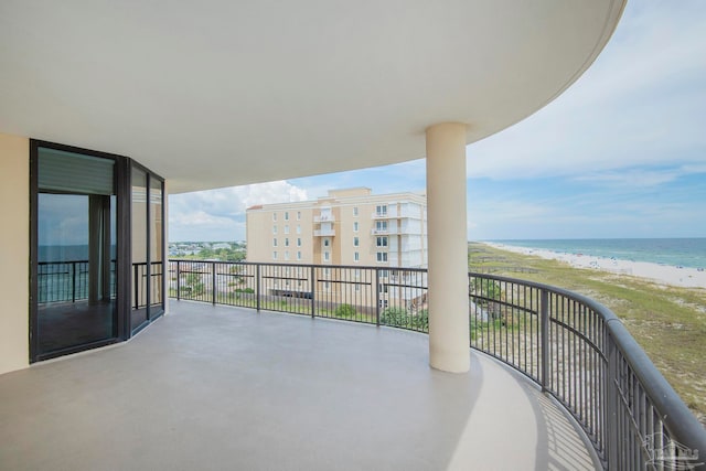 balcony with a beach view and a water view