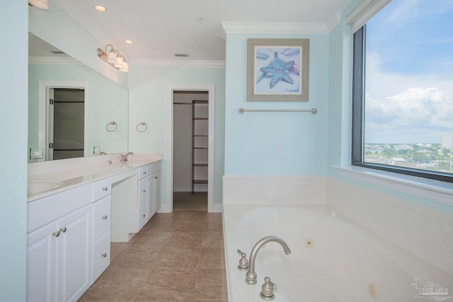 bathroom featuring ornamental molding, vanity, a tub, and tile patterned floors