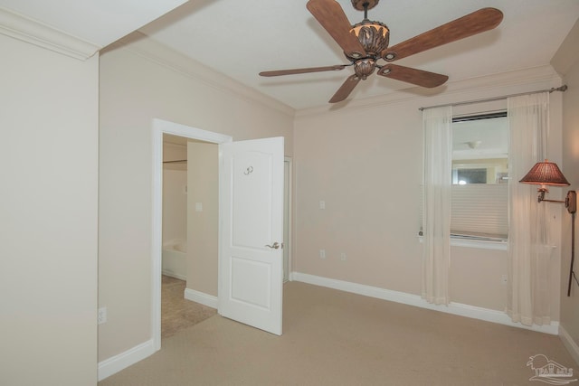 unfurnished bedroom with ceiling fan, crown molding, and light carpet