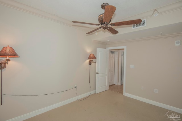 carpeted spare room featuring ornamental molding and ceiling fan