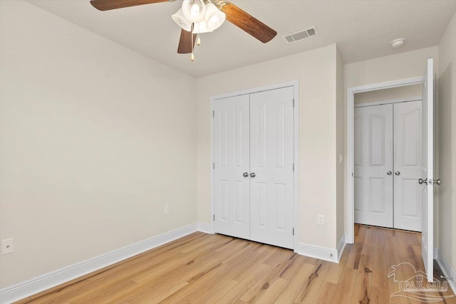 8868 Sanderling Ln, Navarre, FL 32566 - unfurnished bedroom with light wood finished floors, baseboards, a closet, and a ceiling fan