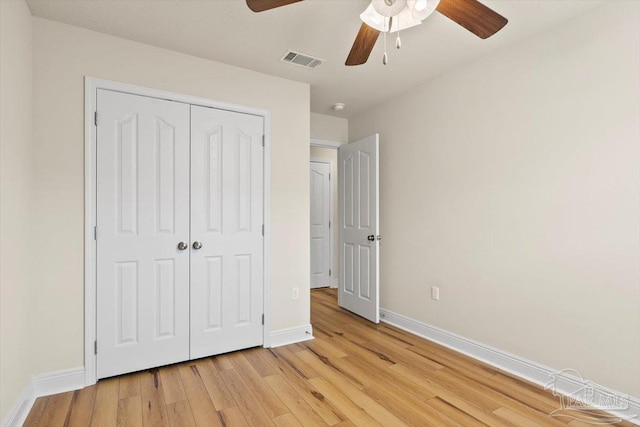 8868 Sanderling Ln, Navarre, FL 32566 - unfurnished bedroom featuring light wood-type flooring, baseboards, a closet, and ceiling fan