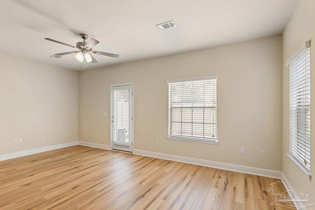 8868 Sanderling Ln, Navarre, FL 32566 - empty room with light wood-style floors, a ceiling fan, and baseboards