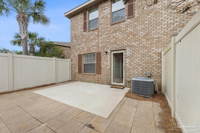 8868 Sanderling Ln, Navarre, FL 32566 - rear view of property with cooling unit, a patio area, and brick siding
