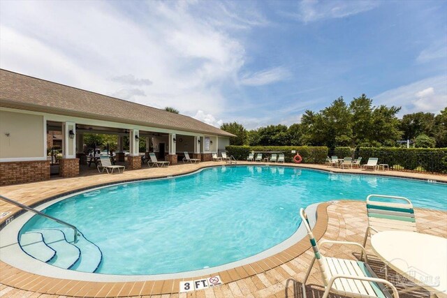 8868 Sanderling Ln, Navarre, FL 32566 - community pool featuring a patio
