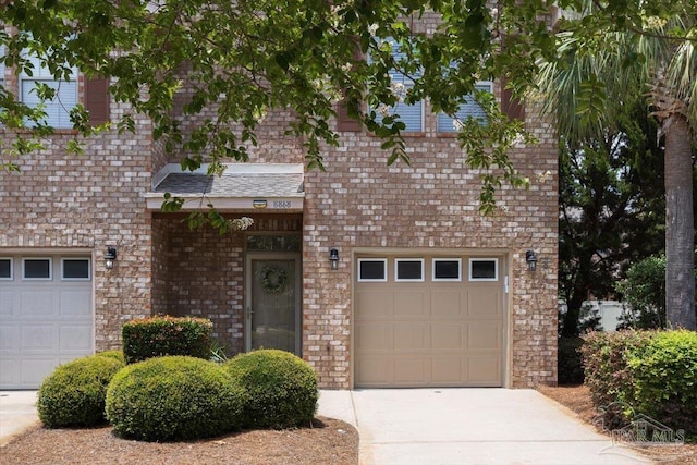 8868 Sanderling Ln, Navarre, FL 32566 - view of front of home featuring driveway, brick siding, and an attached garage