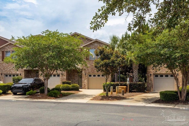 8868 Sanderling Ln, Navarre, FL 32566 - obstructed view of property featuring concrete driveway and brick siding