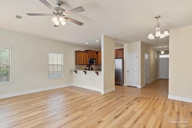 8868 Sanderling Ln, Navarre, FL 32566 - unfurnished living room featuring a chandelier, plenty of natural light, light wood-type flooring, and recessed lighting