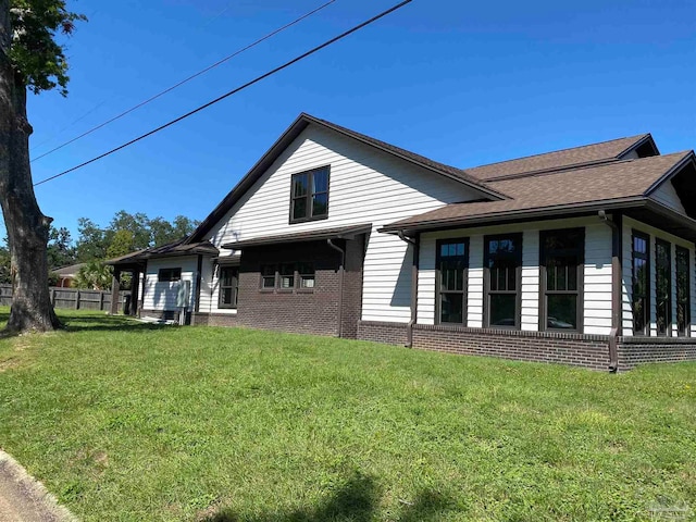 rear view of house with a lawn