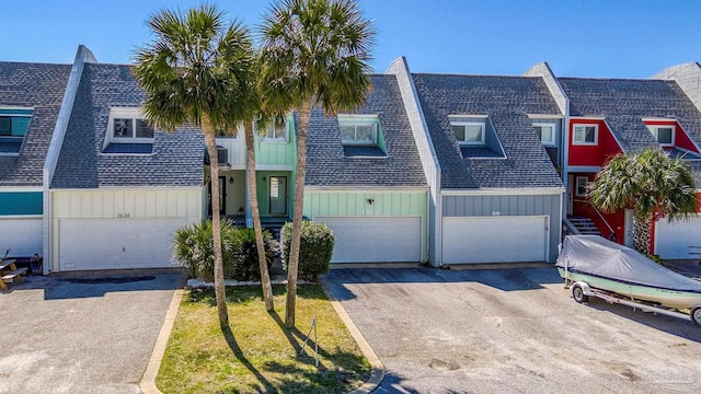 1650 Bulevar Menor, Pensacola Beach, FL 32561 - townhome / multi-family property featuring an attached garage, a shingled roof, and driveway