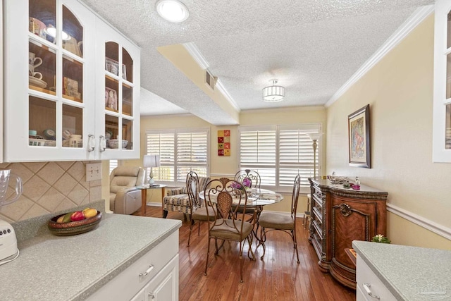1650 Bulevar Menor, Pensacola Beach, FL 32561 - dining space with a textured ceiling, ornamental molding, baseboards, and hardwood / wood-style floors