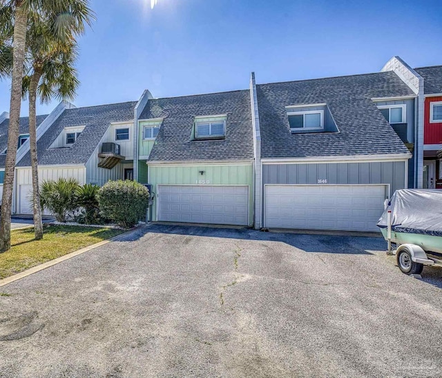 1650 Bulevar Menor, Pensacola Beach, FL 32561 - view of property featuring a shingled roof, board and batten siding, driveway, and a garage