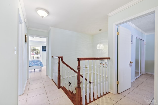 1650 Bulevar Menor, Pensacola Beach, FL 32561 - corridor featuring light tile patterned floors, baseboards, crown molding, and an upstairs landing