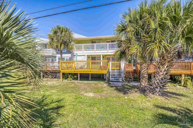 1650 Bulevar Menor, Pensacola Beach, FL 32561 - rear view of house featuring a lawn, a deck, and stairs