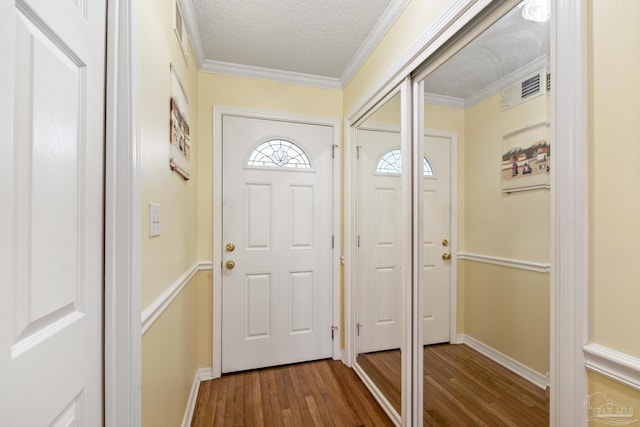 1650 Bulevar Menor, Pensacola Beach, FL 32561 - entryway with visible vents, ornamental molding, a textured ceiling, and dark wood-style floors