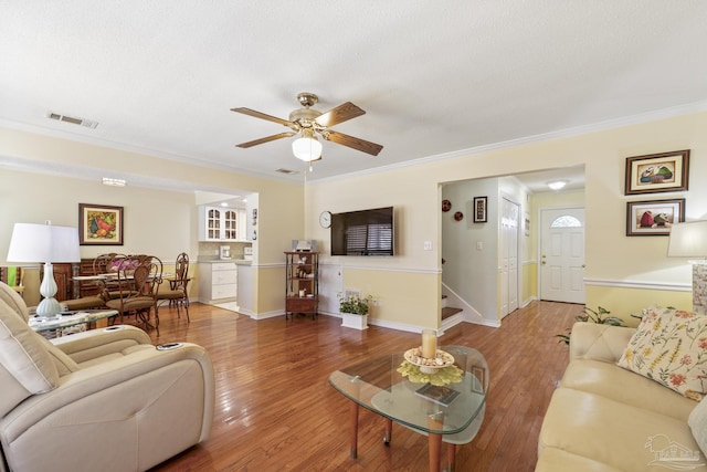 1650 Bulevar Menor, Pensacola Beach, FL 32561 - living area with ceiling fan, visible vents, ornamental molding, and wood finished floors
