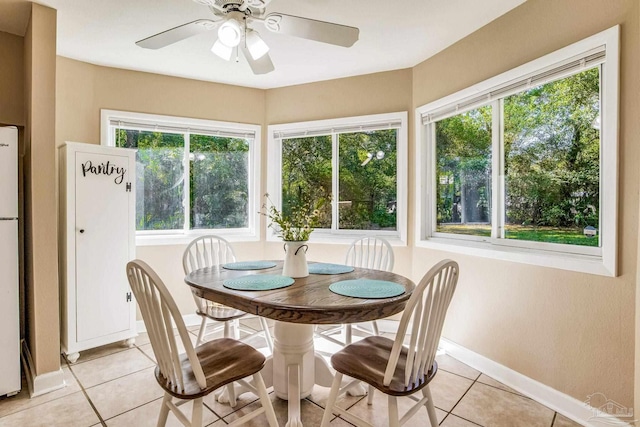 tiled dining area featuring ceiling fan