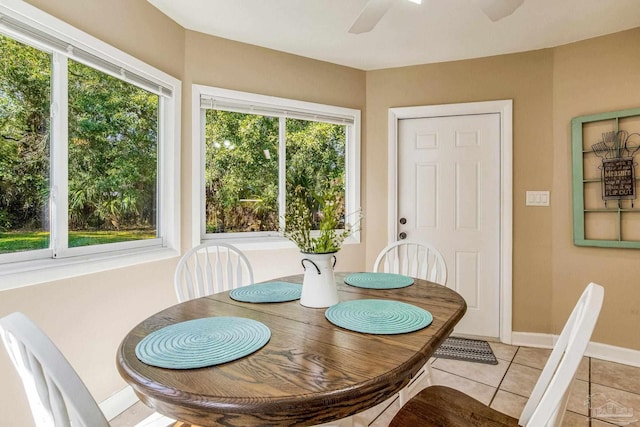 tiled dining area featuring ceiling fan and plenty of natural light