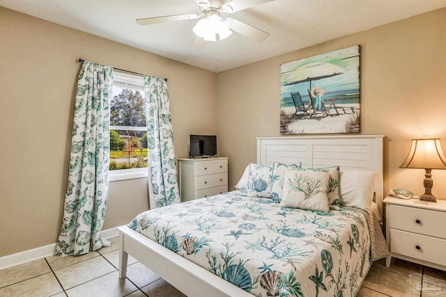 tiled bedroom featuring ceiling fan