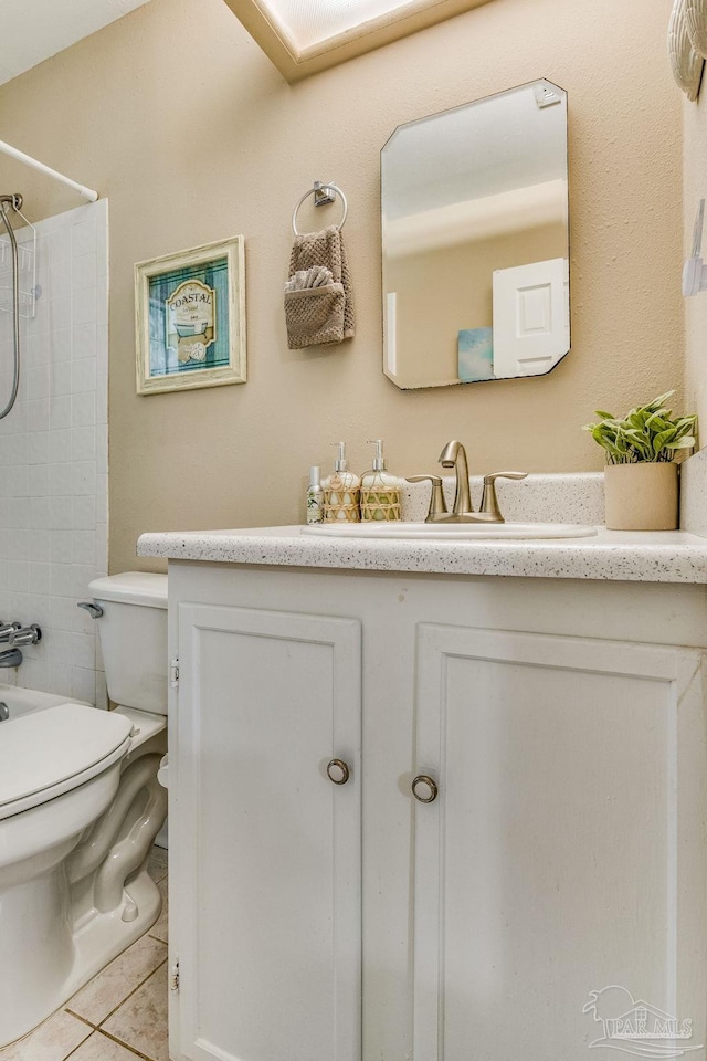 bathroom with toilet, vanity, a shower, and tile patterned floors