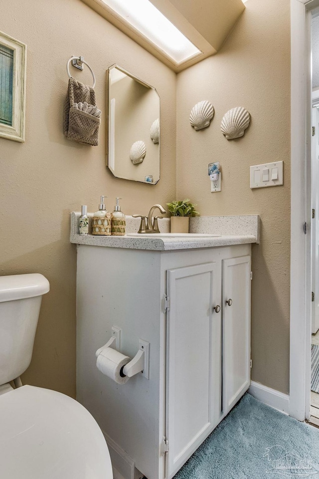 bathroom with toilet and vanity