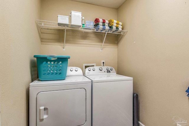 clothes washing area featuring washer and clothes dryer