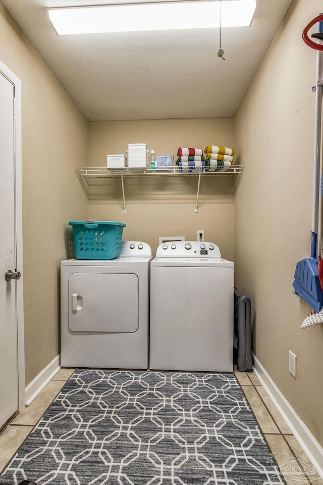 washroom featuring washer and dryer and light tile patterned floors