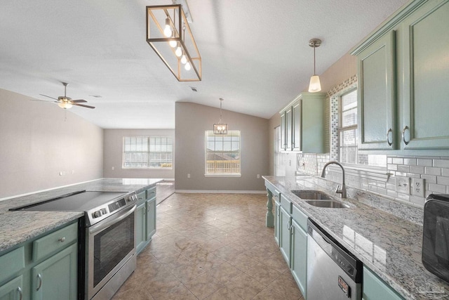 kitchen featuring decorative light fixtures, stainless steel appliances, plenty of natural light, and sink