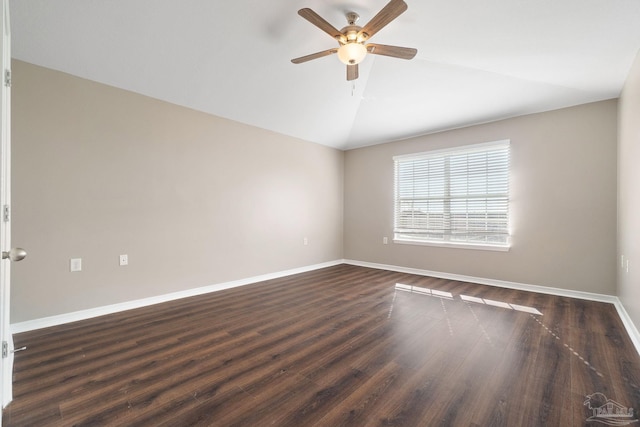 empty room with ceiling fan, dark wood-type flooring, and vaulted ceiling