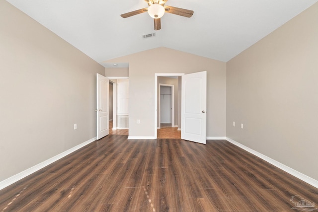 unfurnished bedroom featuring ceiling fan, lofted ceiling, and dark wood-type flooring