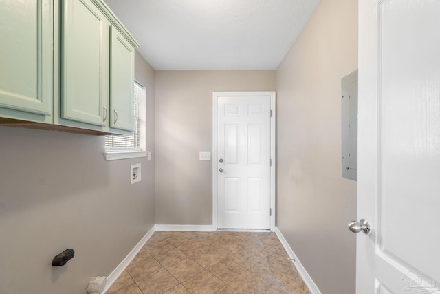 laundry area featuring cabinets, hookup for a washing machine, a textured ceiling, electric panel, and light tile patterned flooring