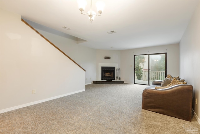 carpeted living room featuring an inviting chandelier