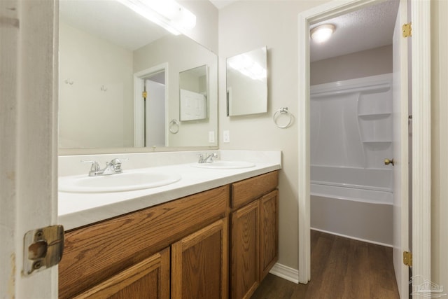 bathroom with vanity, hardwood / wood-style flooring, and walk in shower