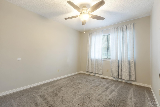 carpeted spare room with a textured ceiling and ceiling fan