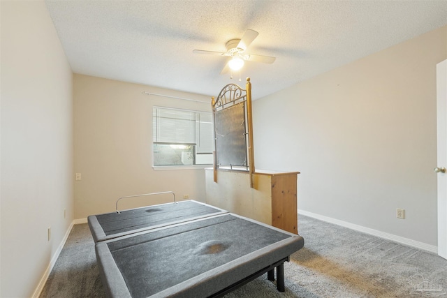 game room with a textured ceiling, carpet floors, and ceiling fan