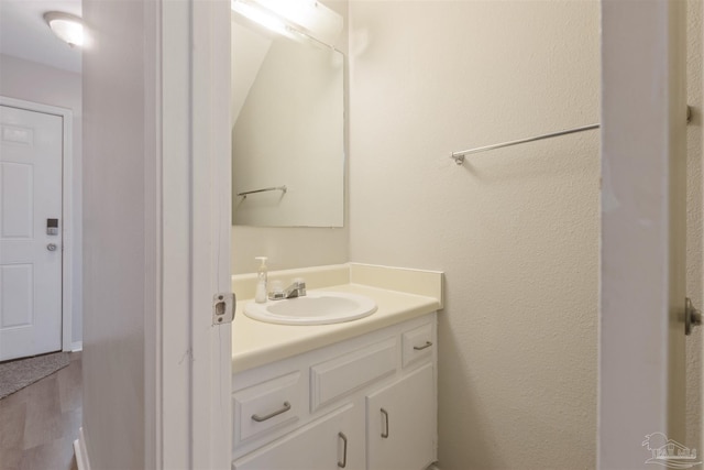 bathroom with vanity and hardwood / wood-style flooring