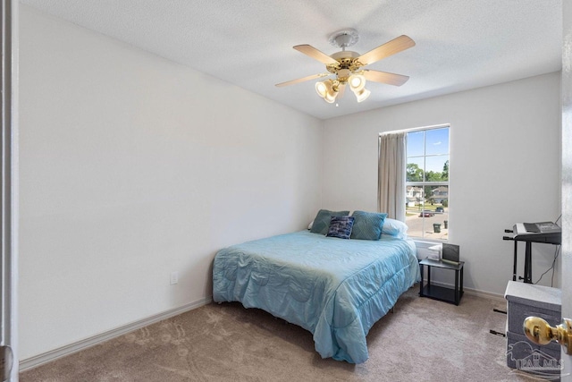 bedroom with ceiling fan, a textured ceiling, and light colored carpet