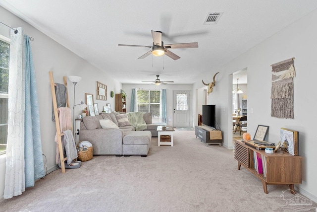 living room with light carpet and ceiling fan