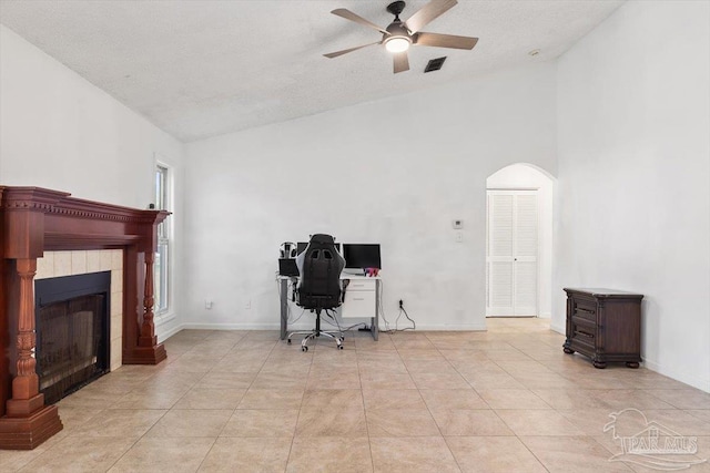 office featuring visible vents, arched walkways, baseboards, and vaulted ceiling