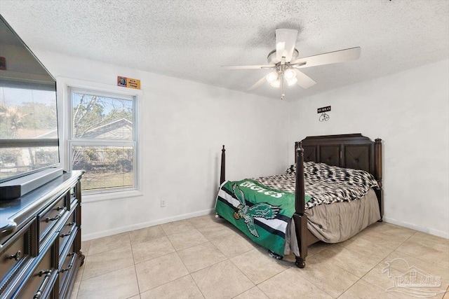 bedroom with a textured ceiling, baseboards, and ceiling fan