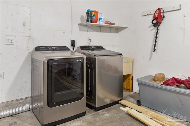 clothes washing area featuring washer and clothes dryer and electric panel