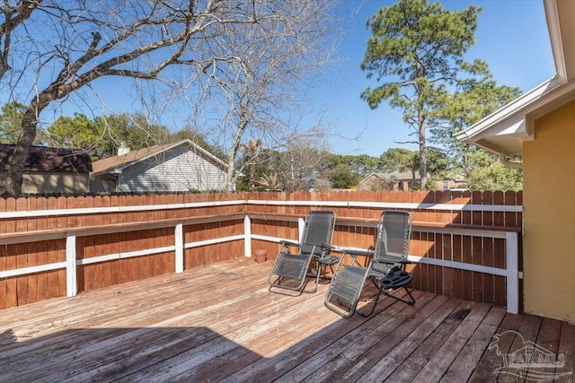 wooden terrace featuring fence