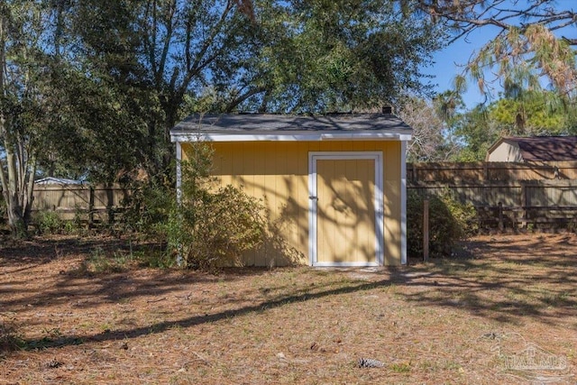 view of shed with fence