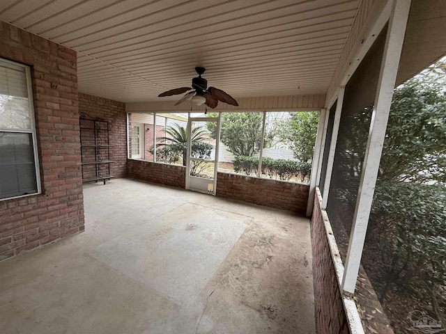 unfurnished sunroom featuring ceiling fan