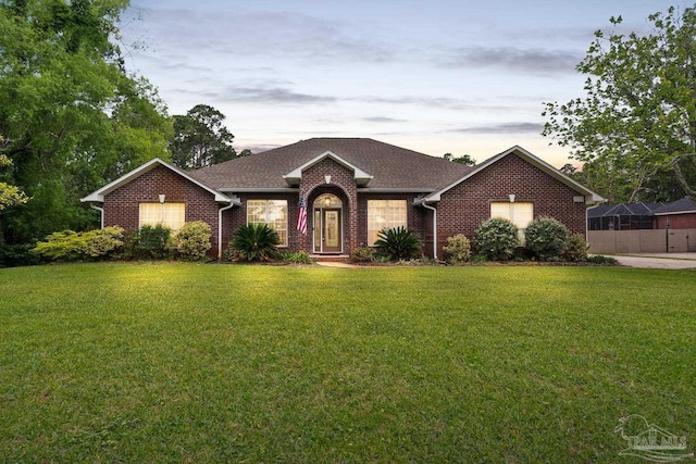 1333 Dubose Rd, Gulf Breeze, FL 32563 - view of front of property featuring a front lawn, brick siding, and a shingled roof