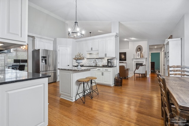1333 Dubose Rd, Gulf Breeze, FL 32563 - kitchen with stainless steel refrigerator with ice dispenser, a chandelier, backsplash, and white cabinets