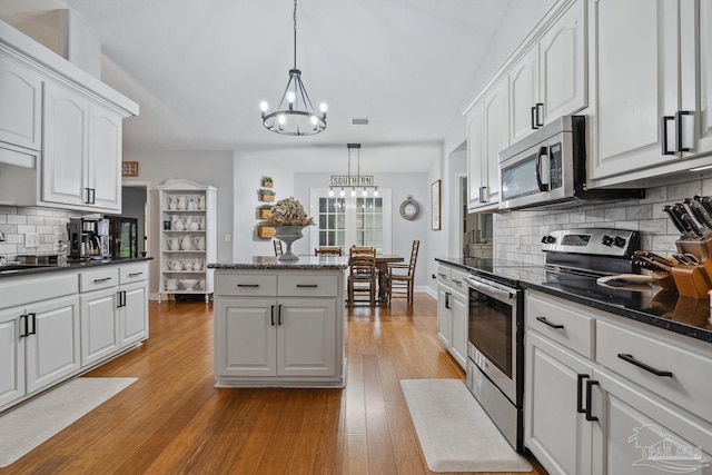 1333 Dubose Rd, Gulf Breeze, FL 32563 - kitchen with stainless steel appliances, a chandelier, light wood-type flooring, and white cabinetry