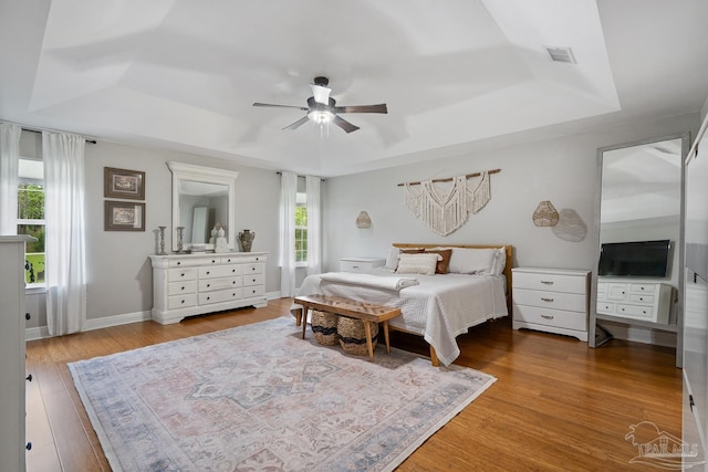 1333 Dubose Rd, Gulf Breeze, FL 32563 - bedroom with a tray ceiling, wood finished floors, and ceiling fan