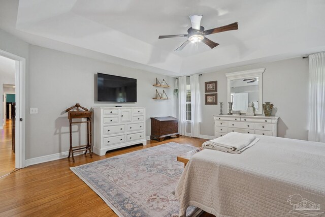 1333 Dubose Rd, Gulf Breeze, FL 32563 - bedroom with light wood-style flooring, a tray ceiling, and baseboards